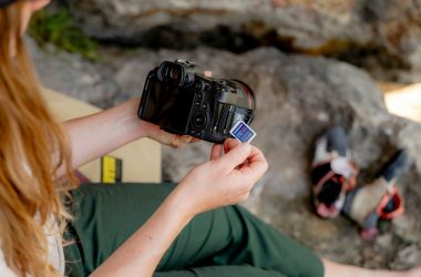 A woman sitting on a chair holding a camera